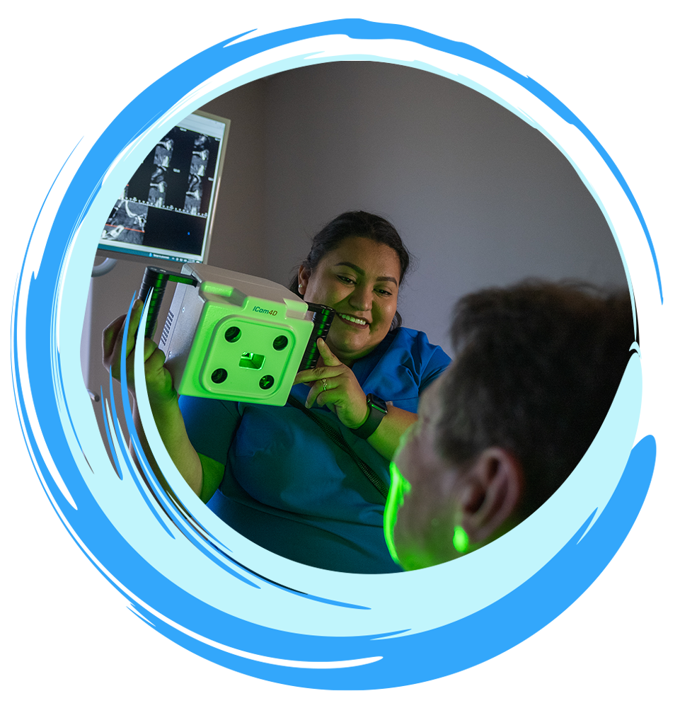team member taking a picture of patient's teeth